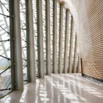 The sunlight entering the Curved Galleries is cut by the exterior ceramic louvers.