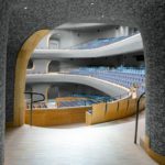 The complex geometry of the Opera Hall is continued to the entrance corridors, creating a homogenously connected double-curved skin.