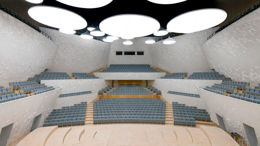 The Concert Hall is designed for a 1000 seat audience. Its walls are in the large scale composed of fractions of sphere surfaces, facing the audience seating area, and providing for the most functional acoustical shaping of the room