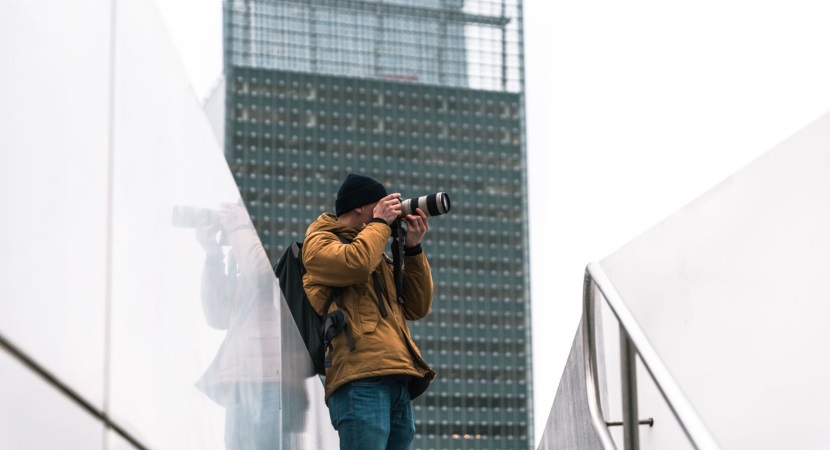 Photographer taking a picture of a building - How to Start with Architecture Photography? 