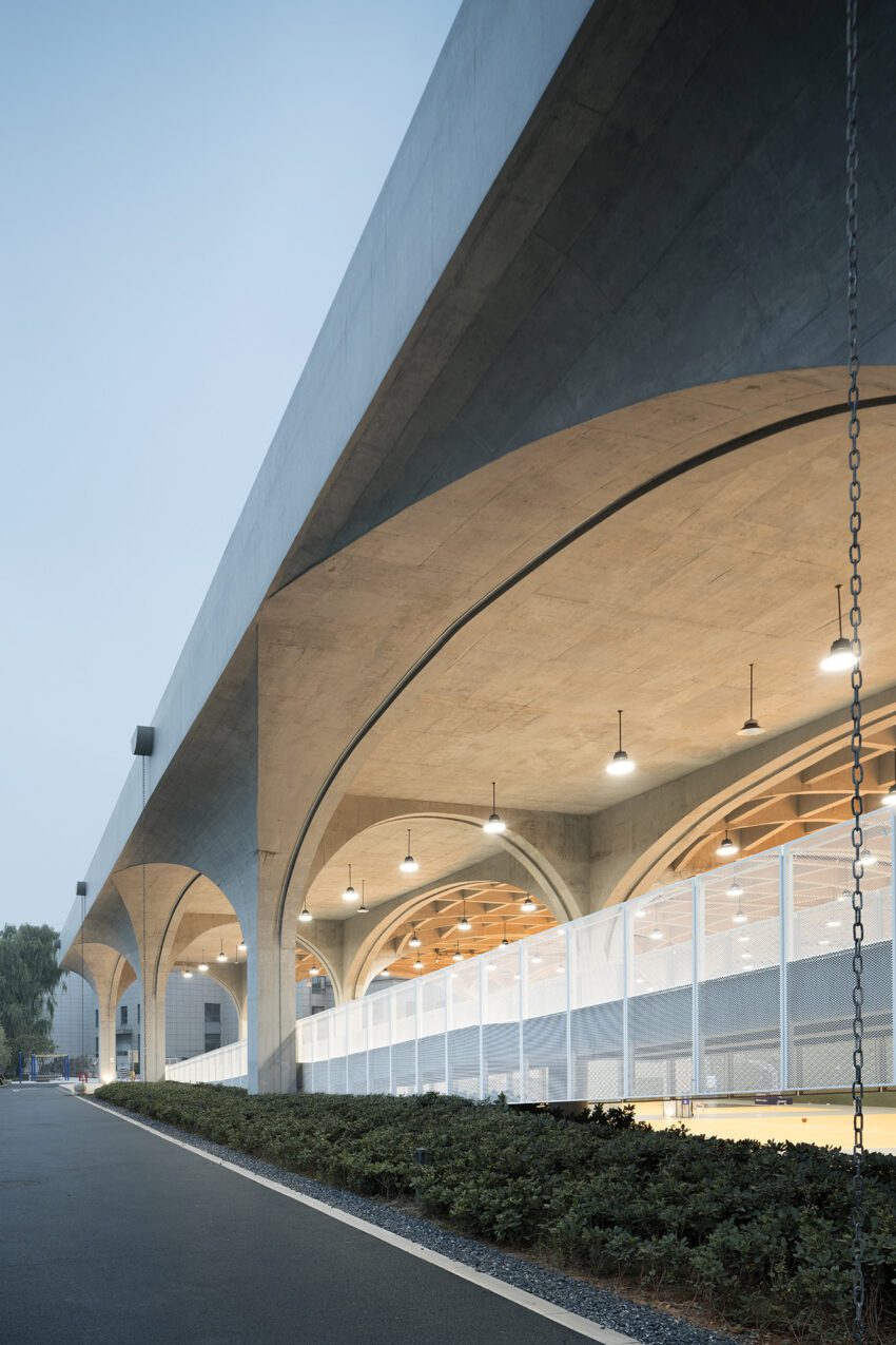 The Hexi Indoor Sports Field of Shaoxing University by UAD Architects Curved Beam Blurs the Building Boundaries